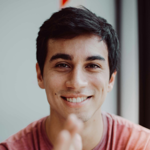 man-smiling-in-red-crew-neck-shirt