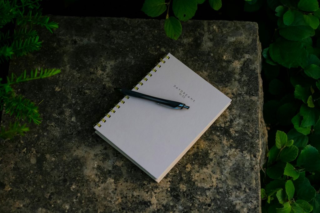 an open notepad with pen resting on it